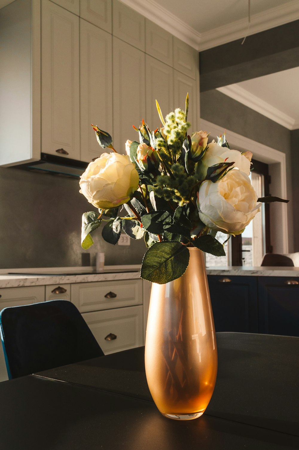 white roses in yellow vase