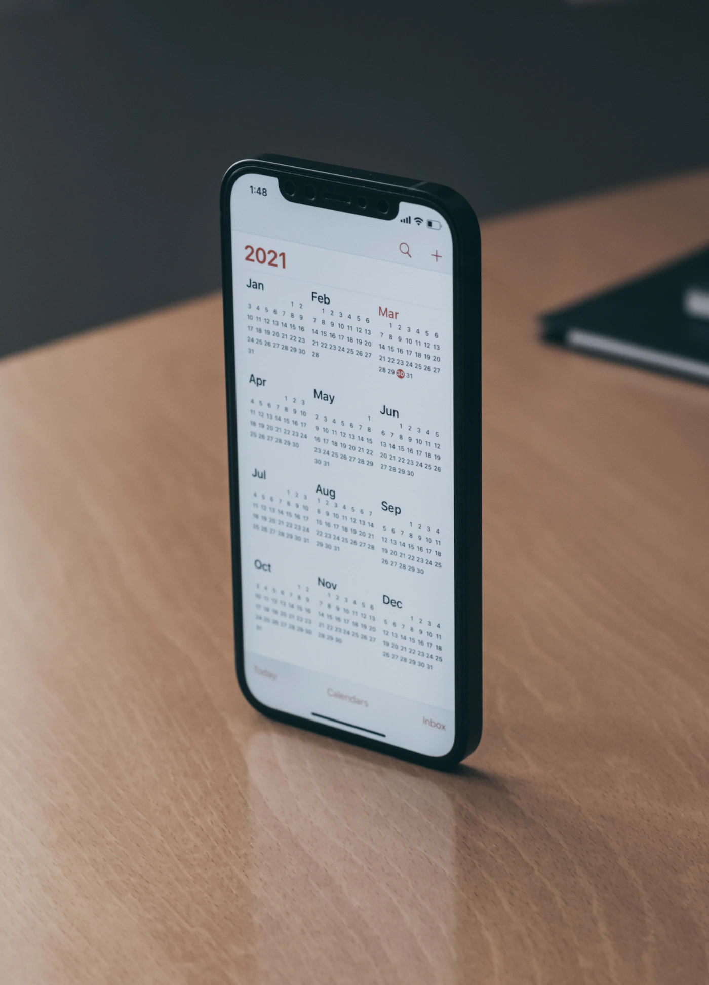 Calendar on a desk with dates marked and highlighted representing planning and scheduling deadlines