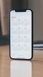 black android smartphone on brown wooden table