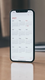black android smartphone on brown wooden table