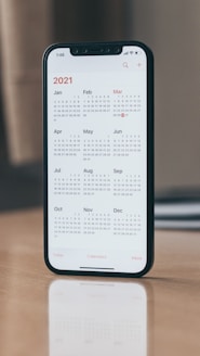 black android smartphone on brown wooden table