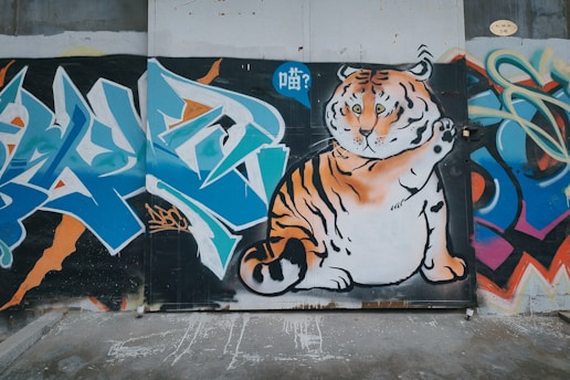 A vibrant mural of a roaring beast bursting through urban graffiti walls.