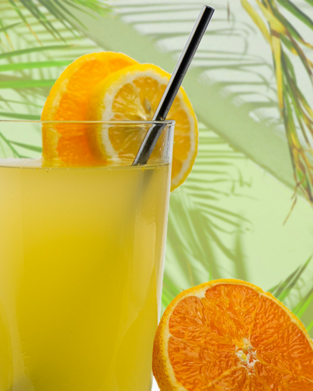 orange juice in clear drinking glass