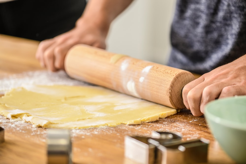 brown wooden rolling pin on brown wooden table