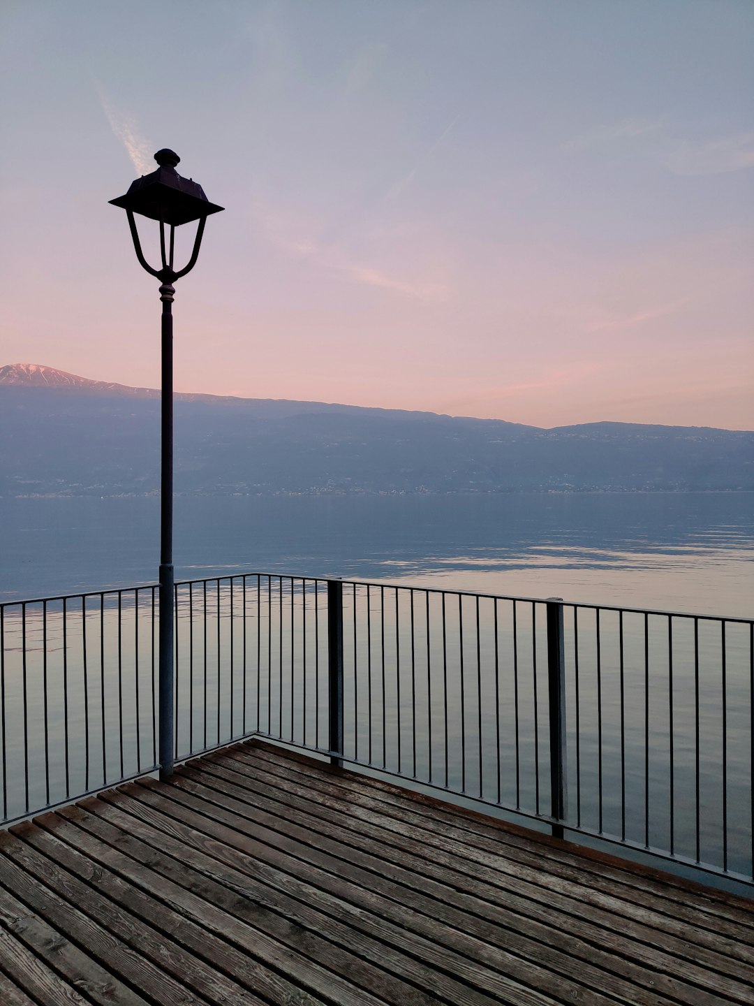 black and white lamp post on brown wooden dock during daytime