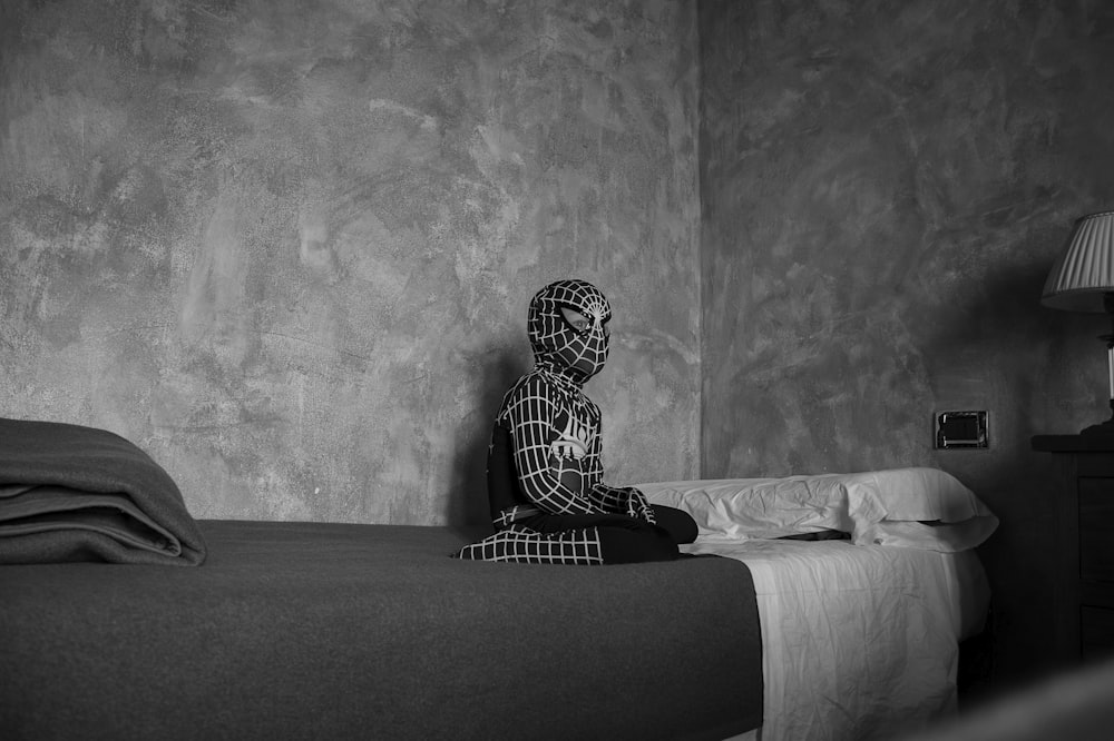 woman in black and white long sleeve dress sitting on black and white bed