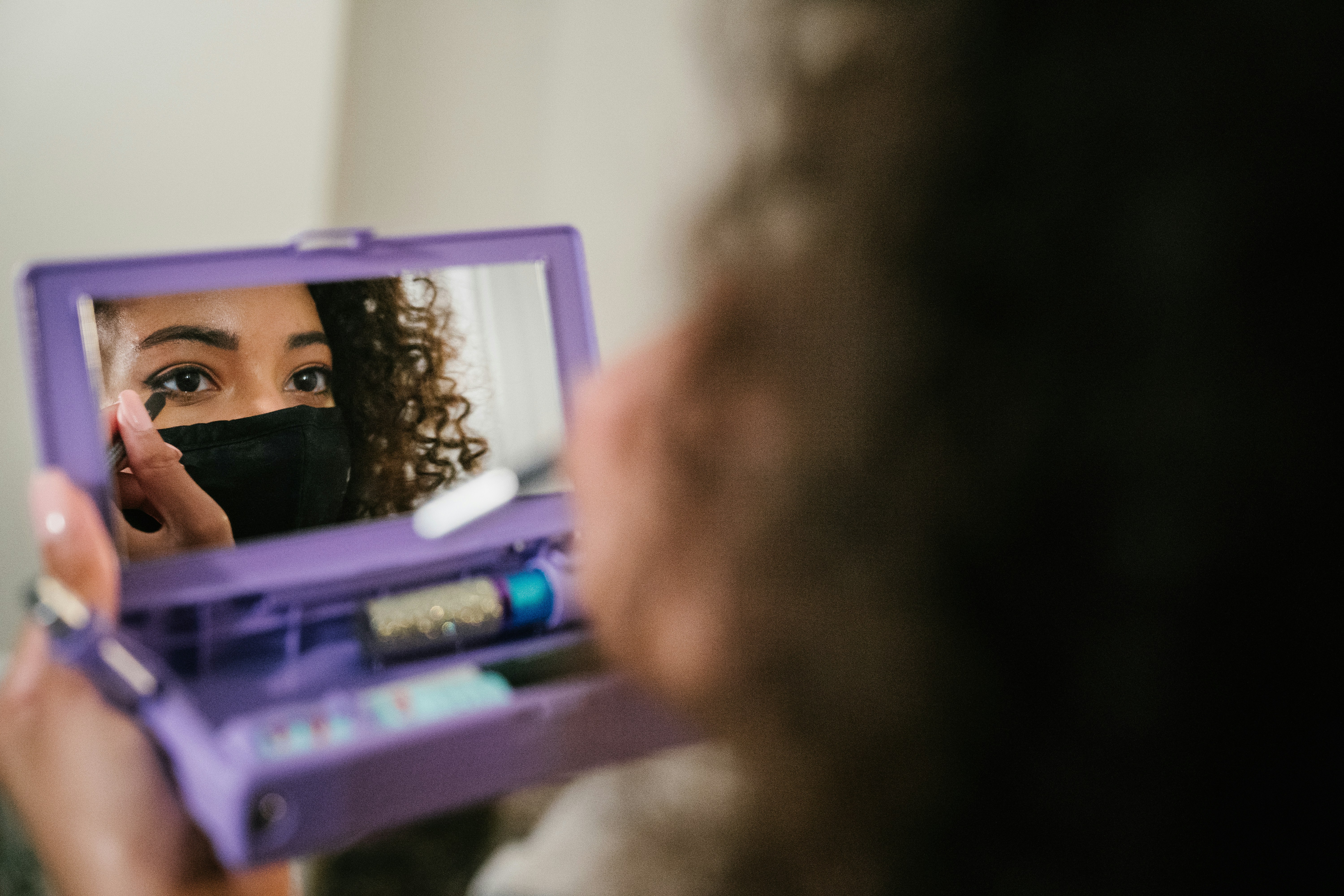 girl in pink shirt holding purple frame
