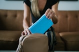 woman in black shirt holding blue tablet computer case