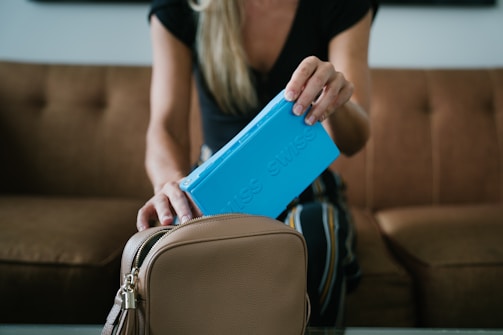 woman in black shirt holding blue tablet computer case