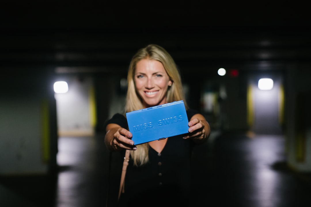 woman holding blue book during night time