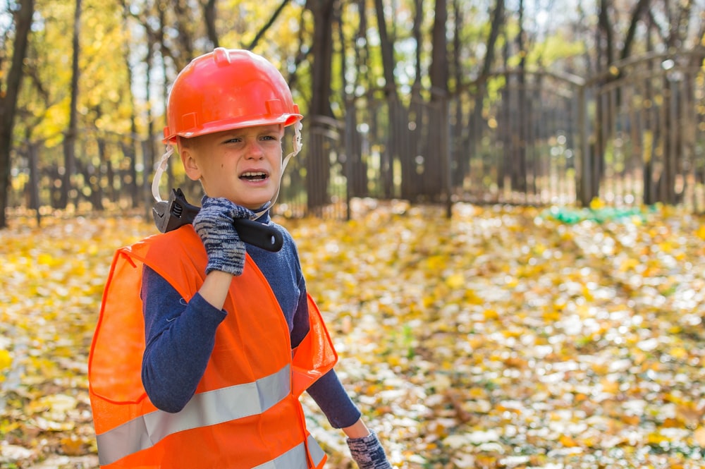 boy in orange helmet and blue and orange jacket