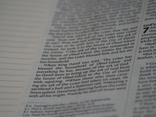 A close-up view of a page from a book, featuring columns of printed text with some words in uppercase for emphasis. The text appears neatly organized in paragraphs, and black ink is used on a white or slightly off-white paper background.
