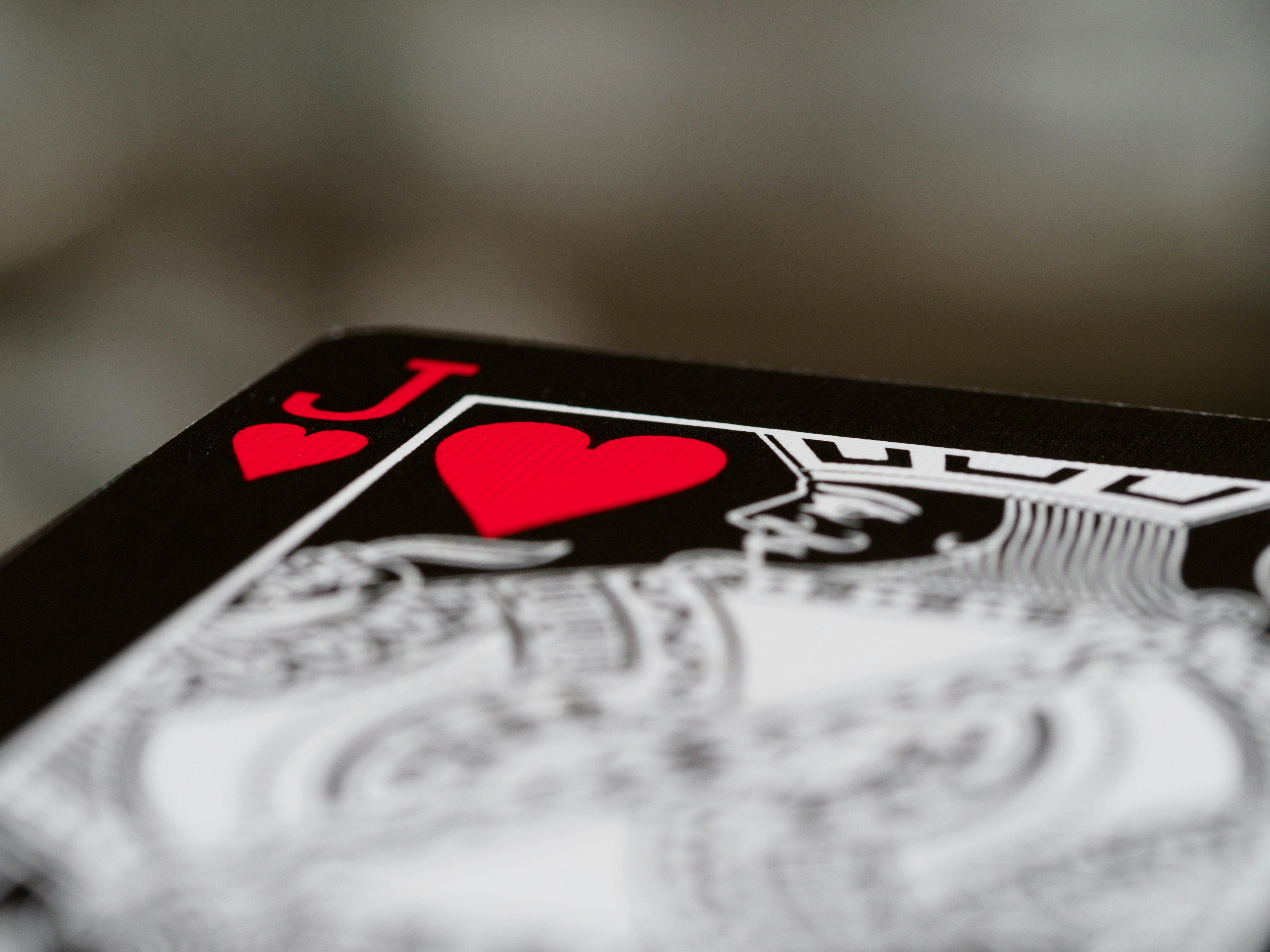 cards, playing cards, gambling, close up, bokeh, wood background, product shot, focus, deal, jack of hearts,