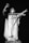 A dramatic statue of a robed figure with outstretched arms, appearing to be in a gesture of command or invoking. The figure's expression is intense and the robes suggest a historic or religious significance, with a monochrome color scheme adding to the dramatic effect.