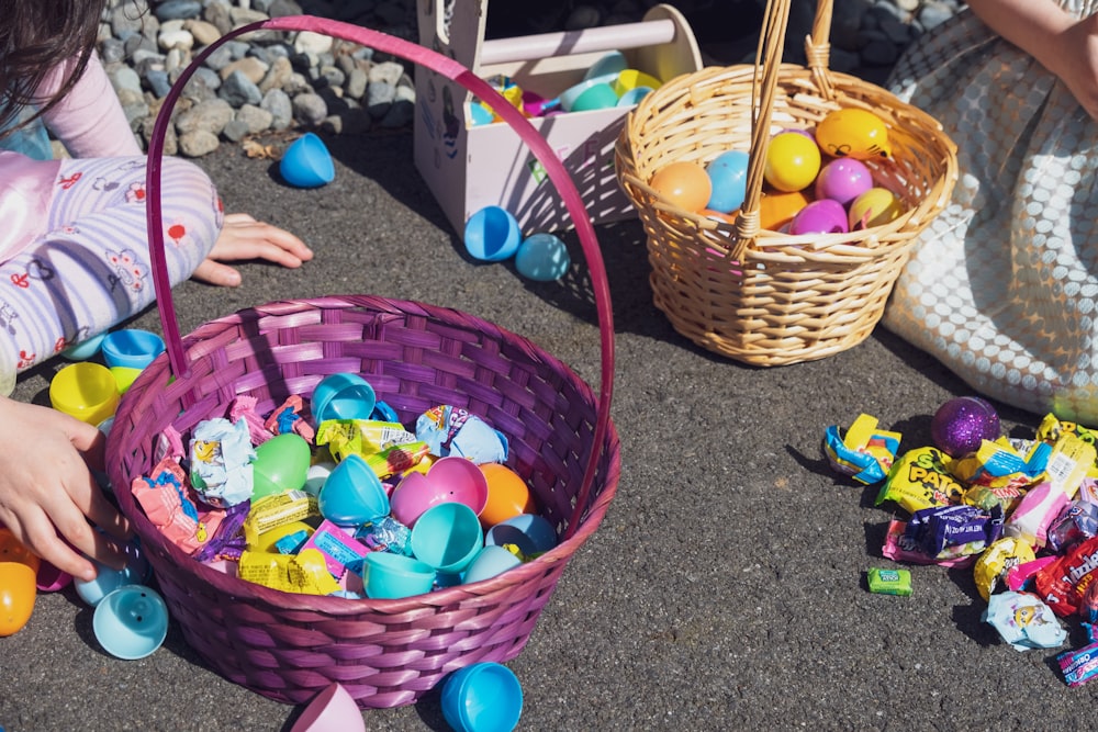 assorted color plastic toys in brown woven basket