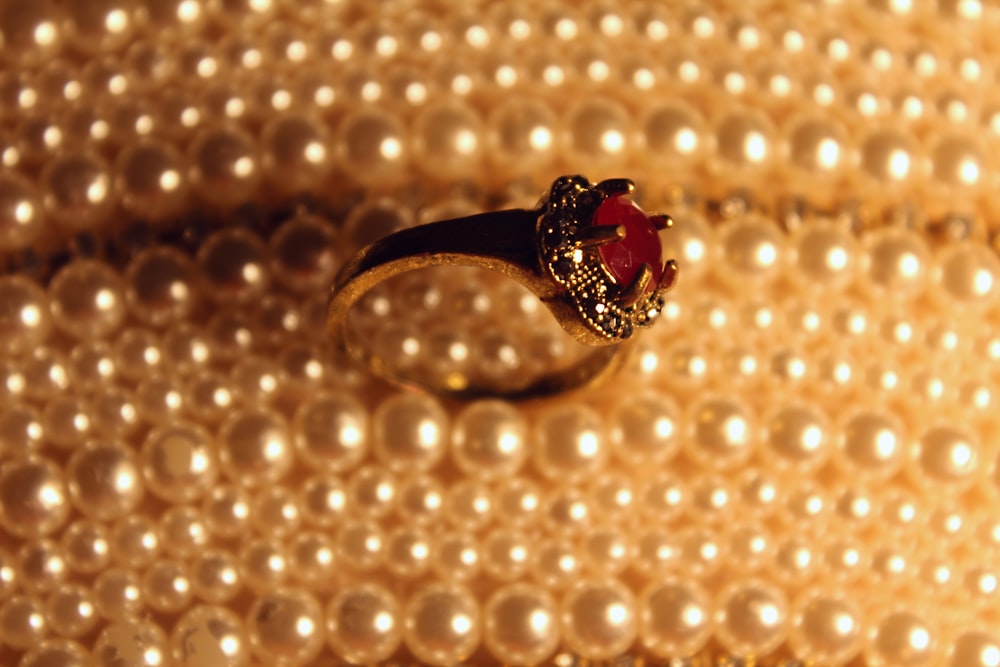 silver and red gemstone ring