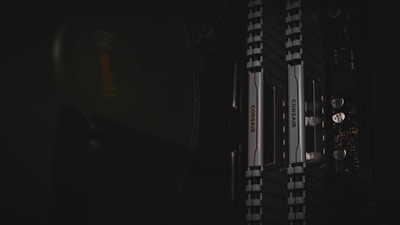 A set of DDR4 RAM sticks with vibrant blue heatsinks arranged neatly on a dark surface.