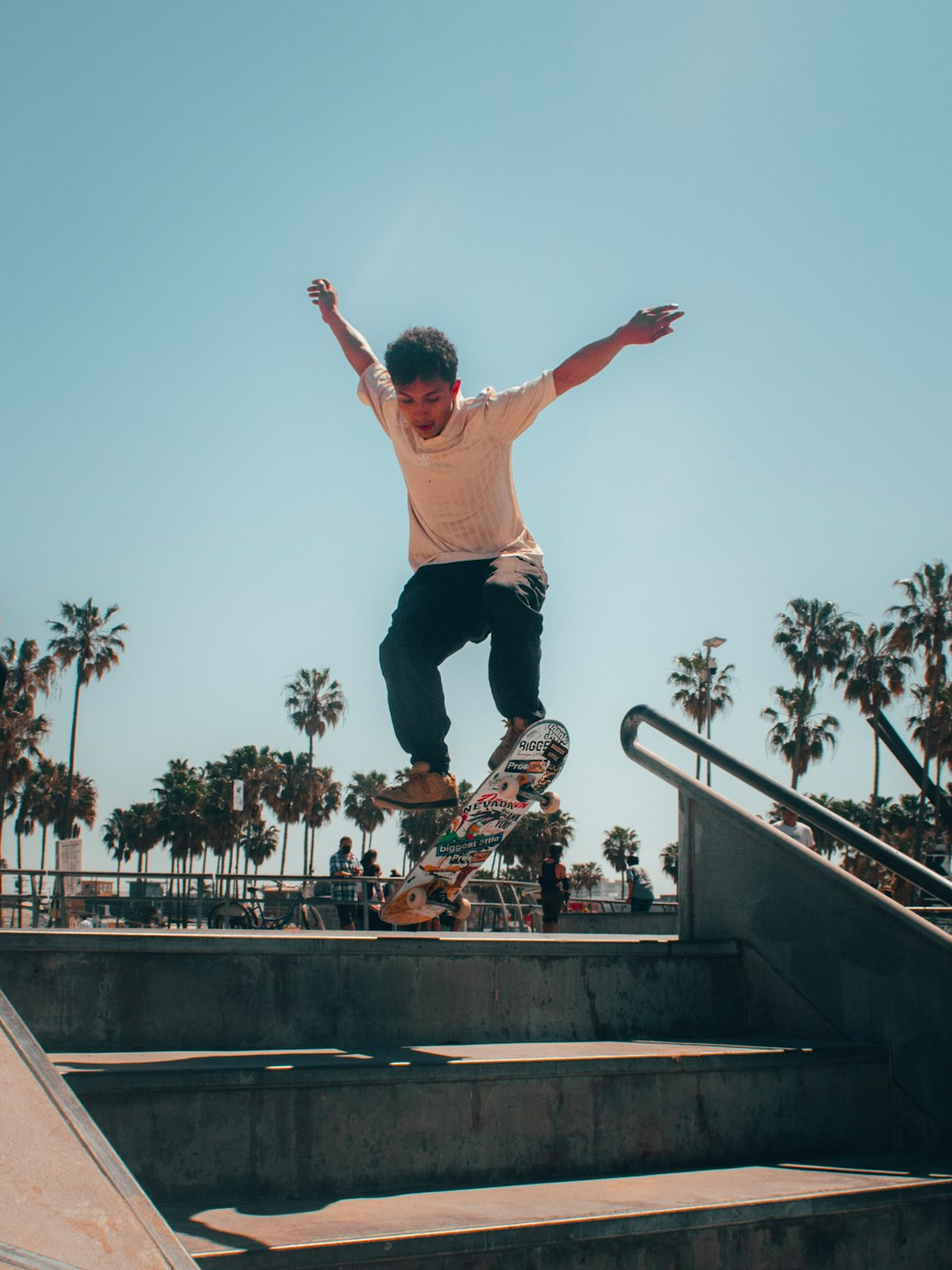 man in brown tank top and black pants doing skateboard stunts on black skateboard ramp