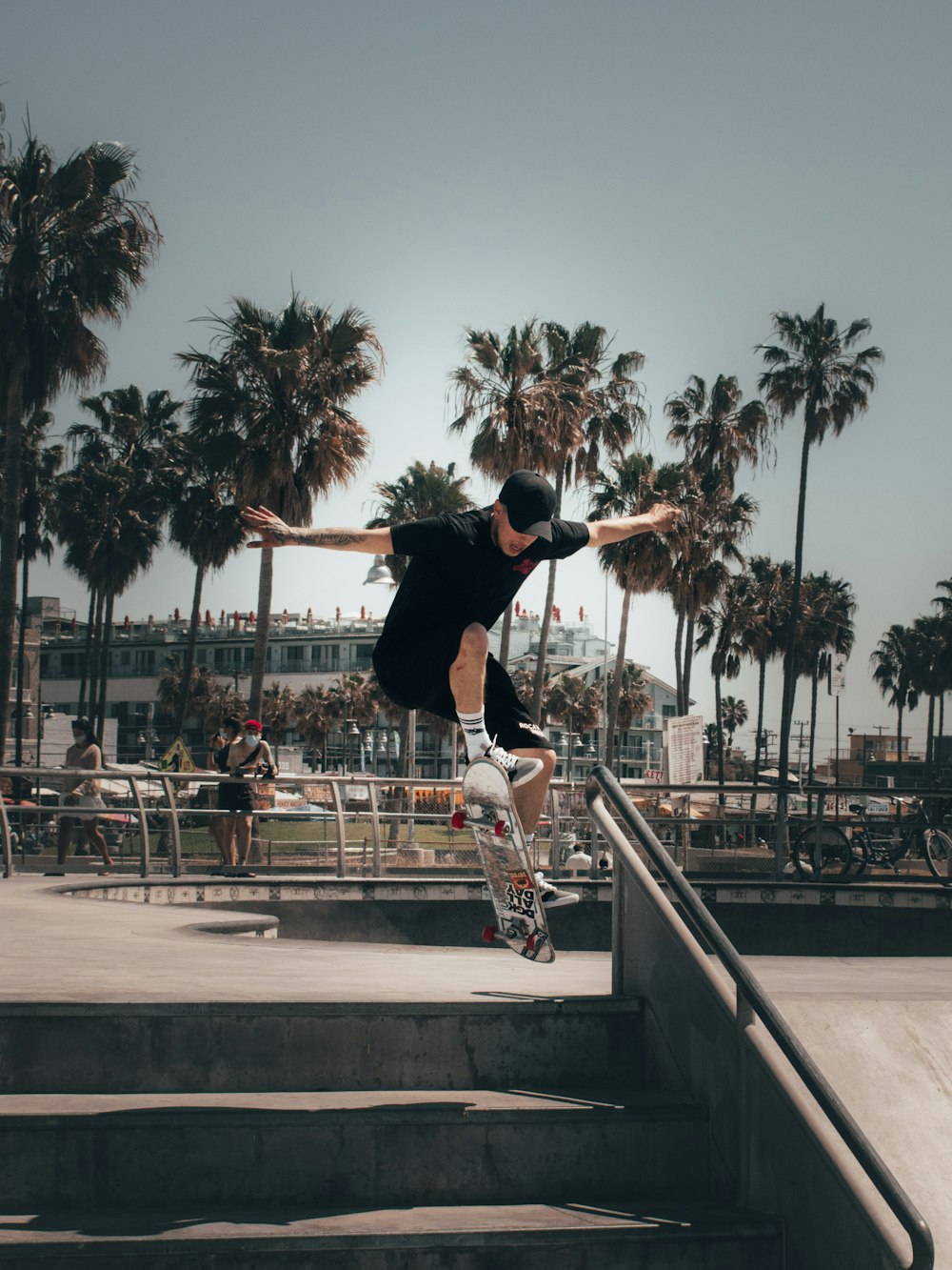 man in black shirt and black pants riding skateboard during daytime