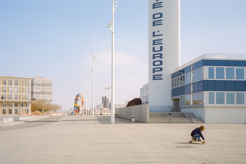 people walking on street near white and blue building during daytime