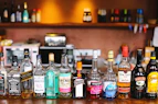 assorted glass bottles on brown wooden table