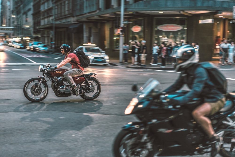 people riding motorcycle on road during daytime