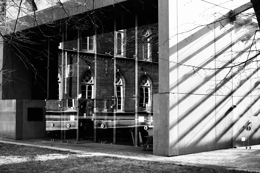 grayscale photo of building with glass windows