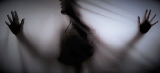 silhouette of person standing near white wall