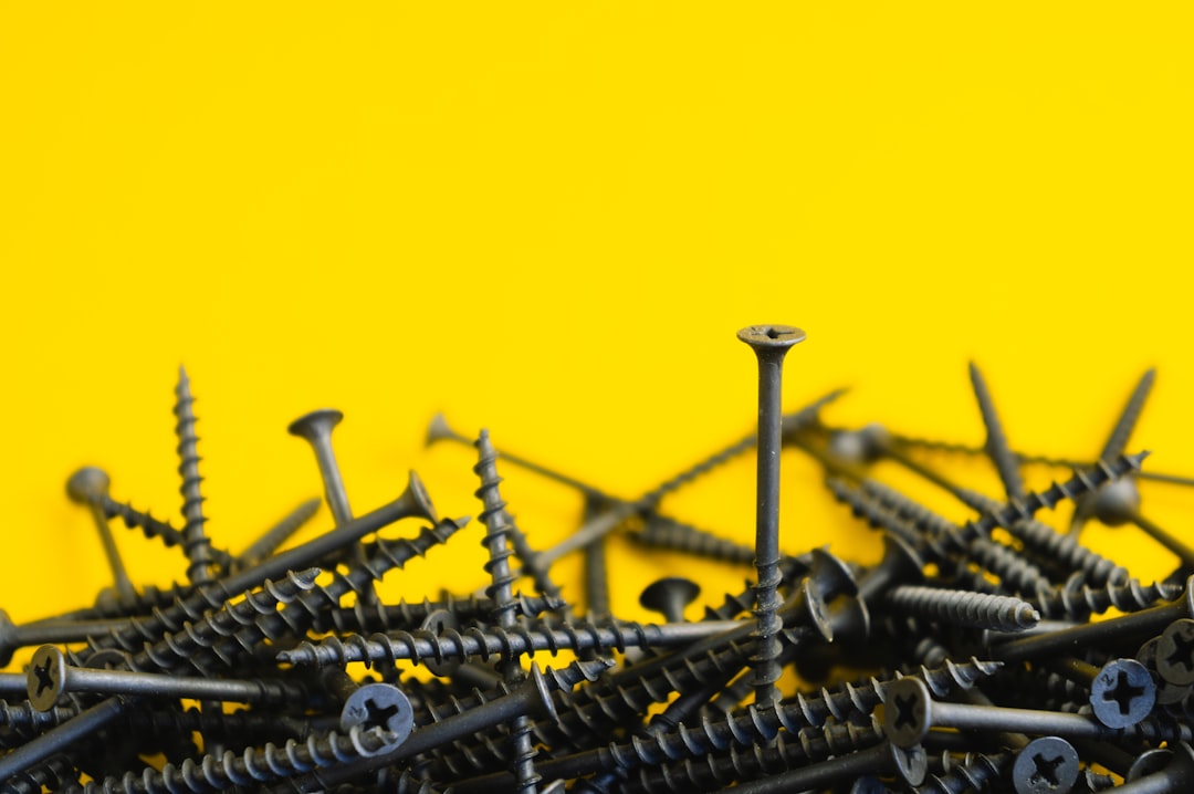 gray metal nails on yellow surface,