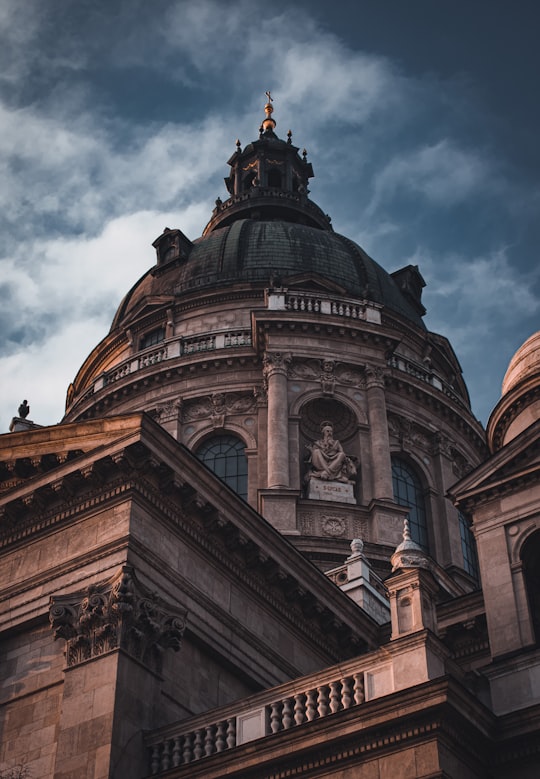 brown and black concrete building under cloudy sky during daytime in Saint Stephen's Basilica Hungary