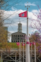 white and brown concrete building near bare trees during daytime