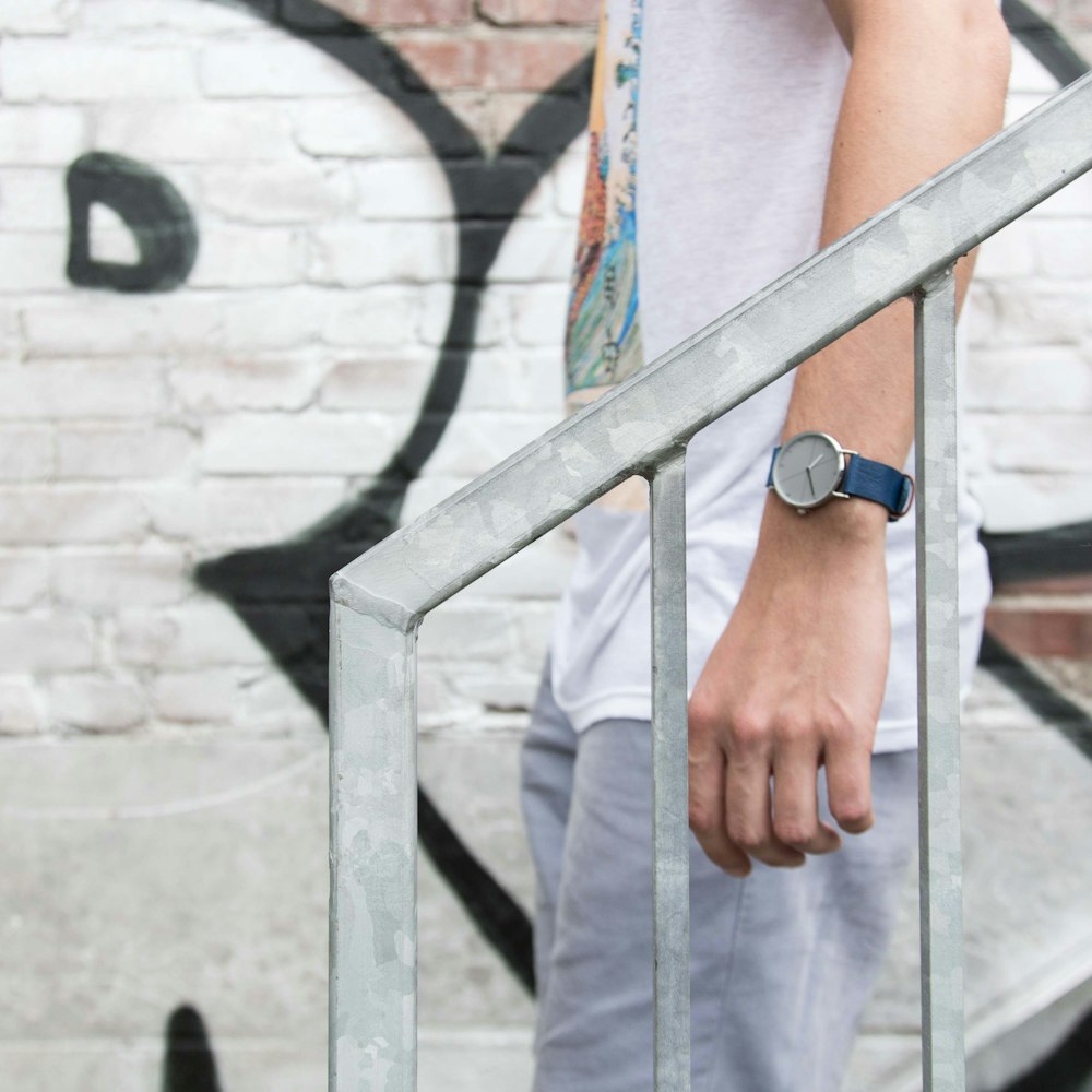 man in brown pants wearing blue and white watch