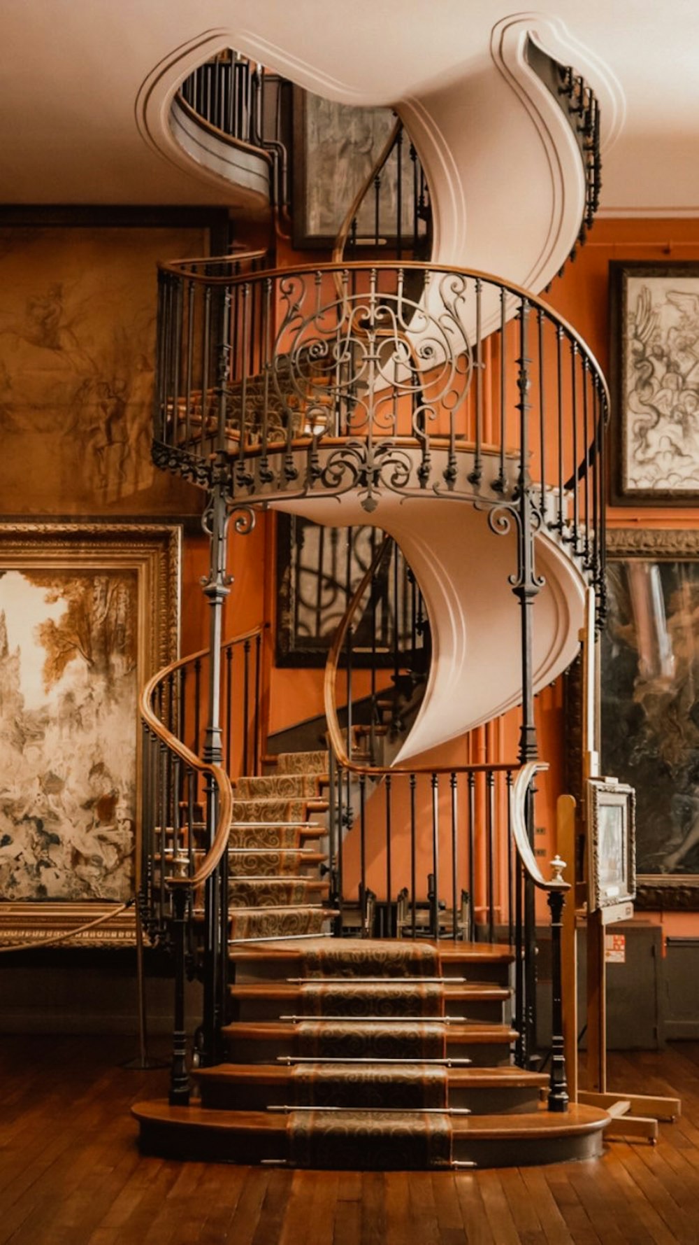 brown spiral staircase with brown steel railings