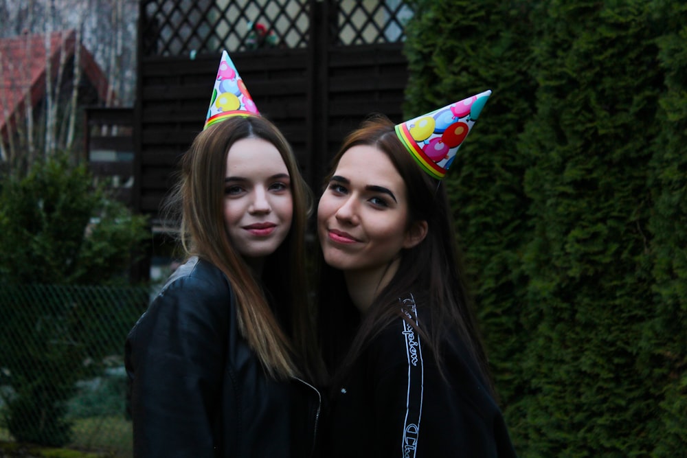 2 women wearing black jacket smiling