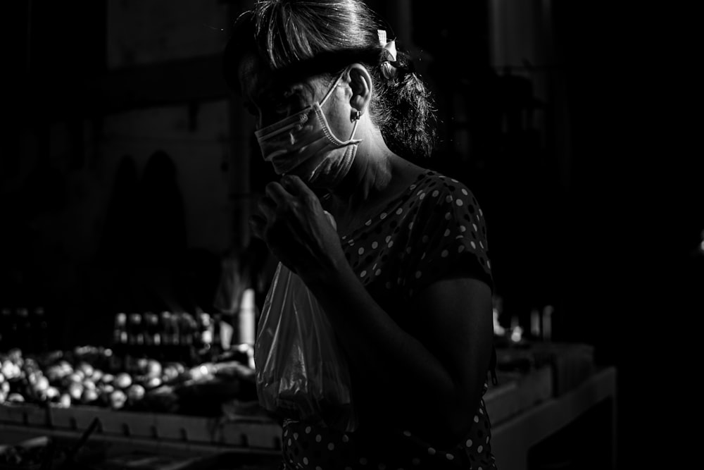 woman in black and white polka dot shirt wearing black framed eyeglasses