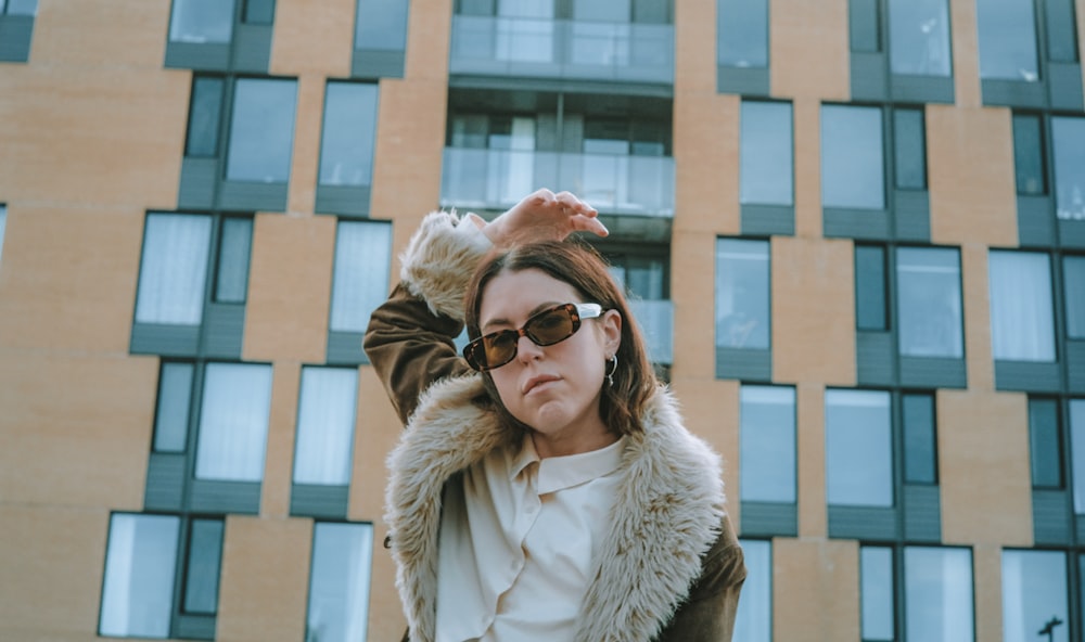 woman in white fur coat wearing brown sunglasses