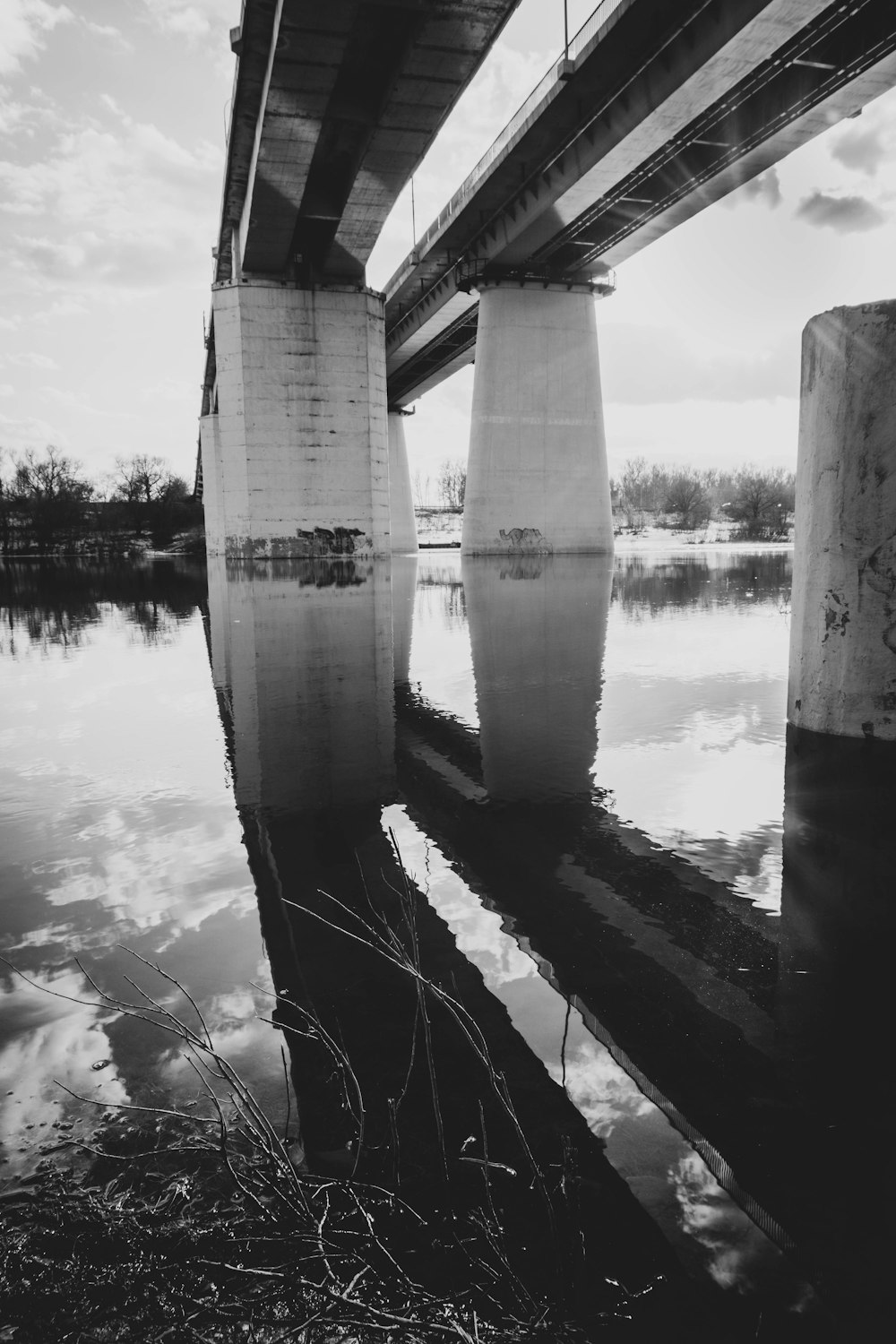 grayscale photo of bridge over river