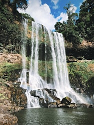 waterfalls under blue sky during daytime