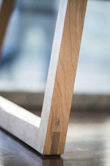 Close-up of a sleek, engineered reclaimed wood panel highlighting its smooth grain and precise finish in a modern interior.