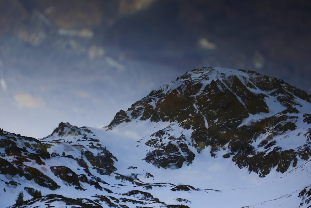 snow covered mountain under cloudy sky during daytime