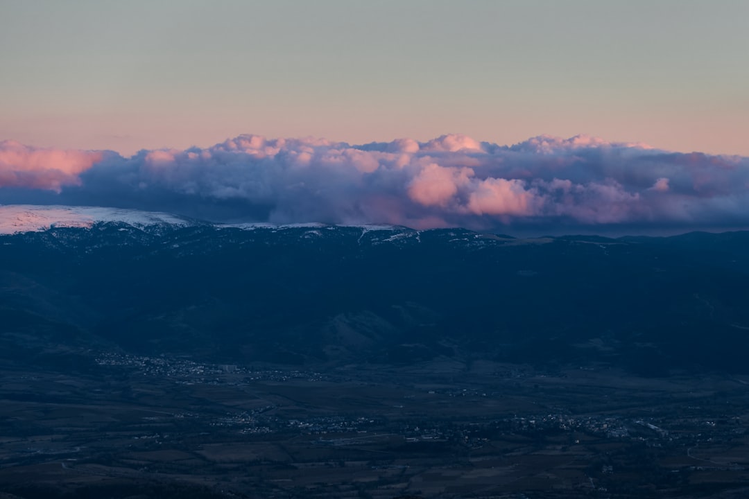 white clouds over mountains during daytime