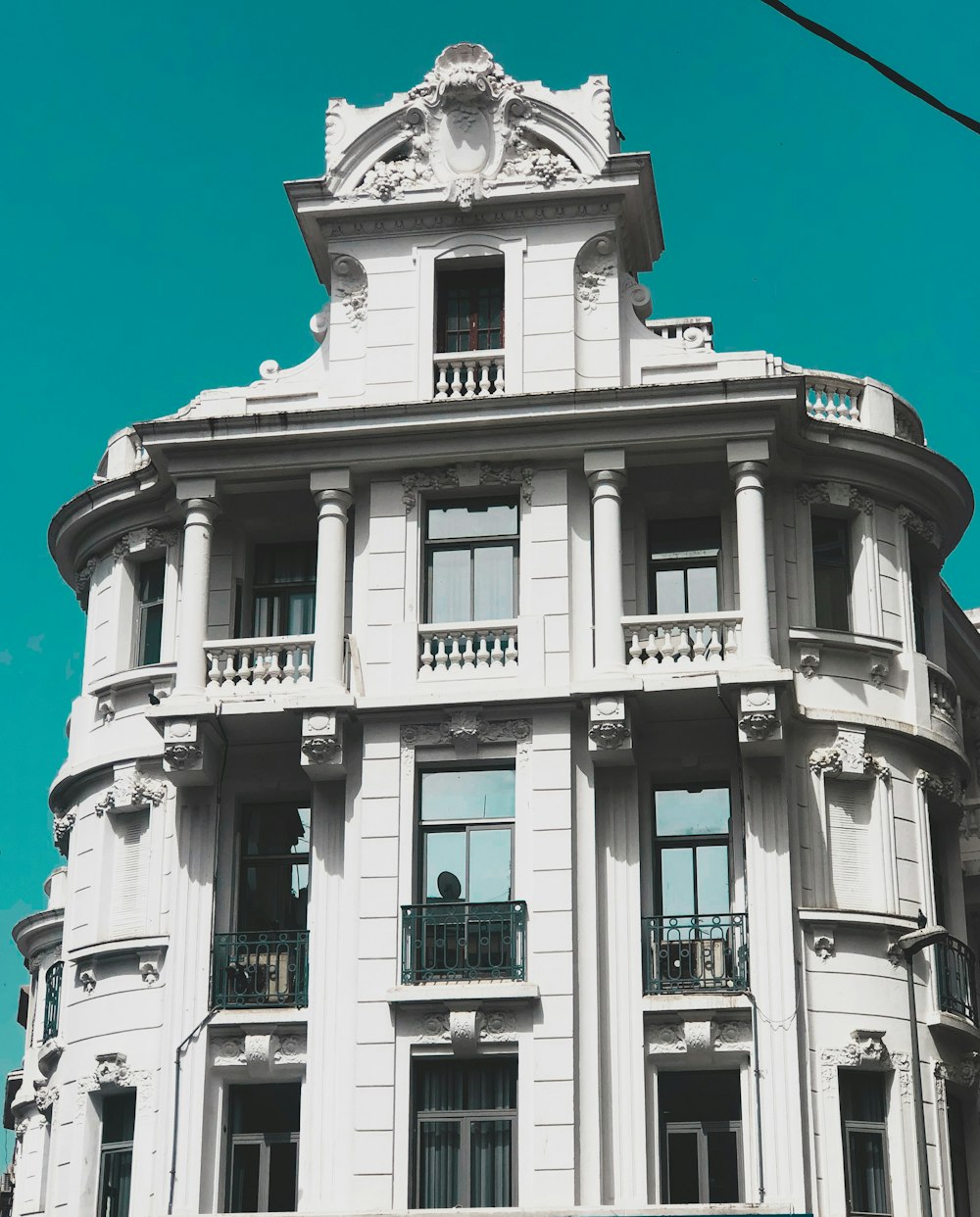 a large white building with a clock on the top of it