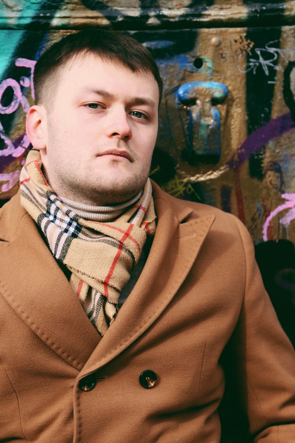 man in brown coat standing