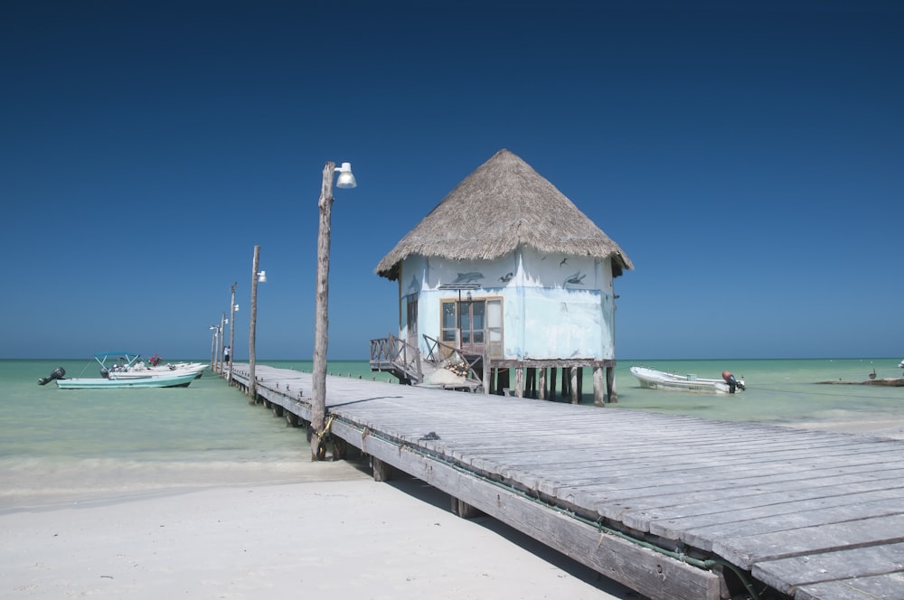 brown wooden beach house on beach during daytime