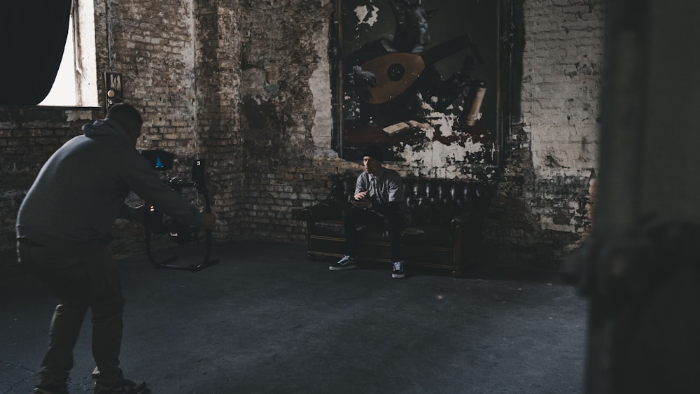 people standing in front of brown brick wall