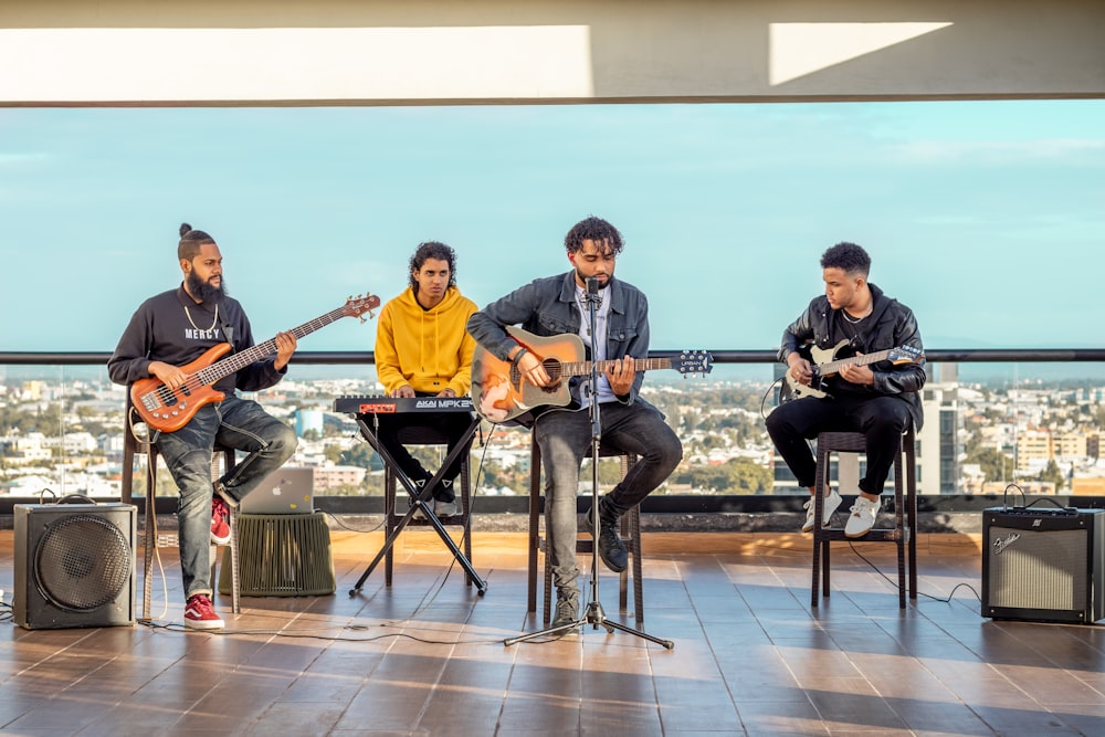 4 men playing musical instruments