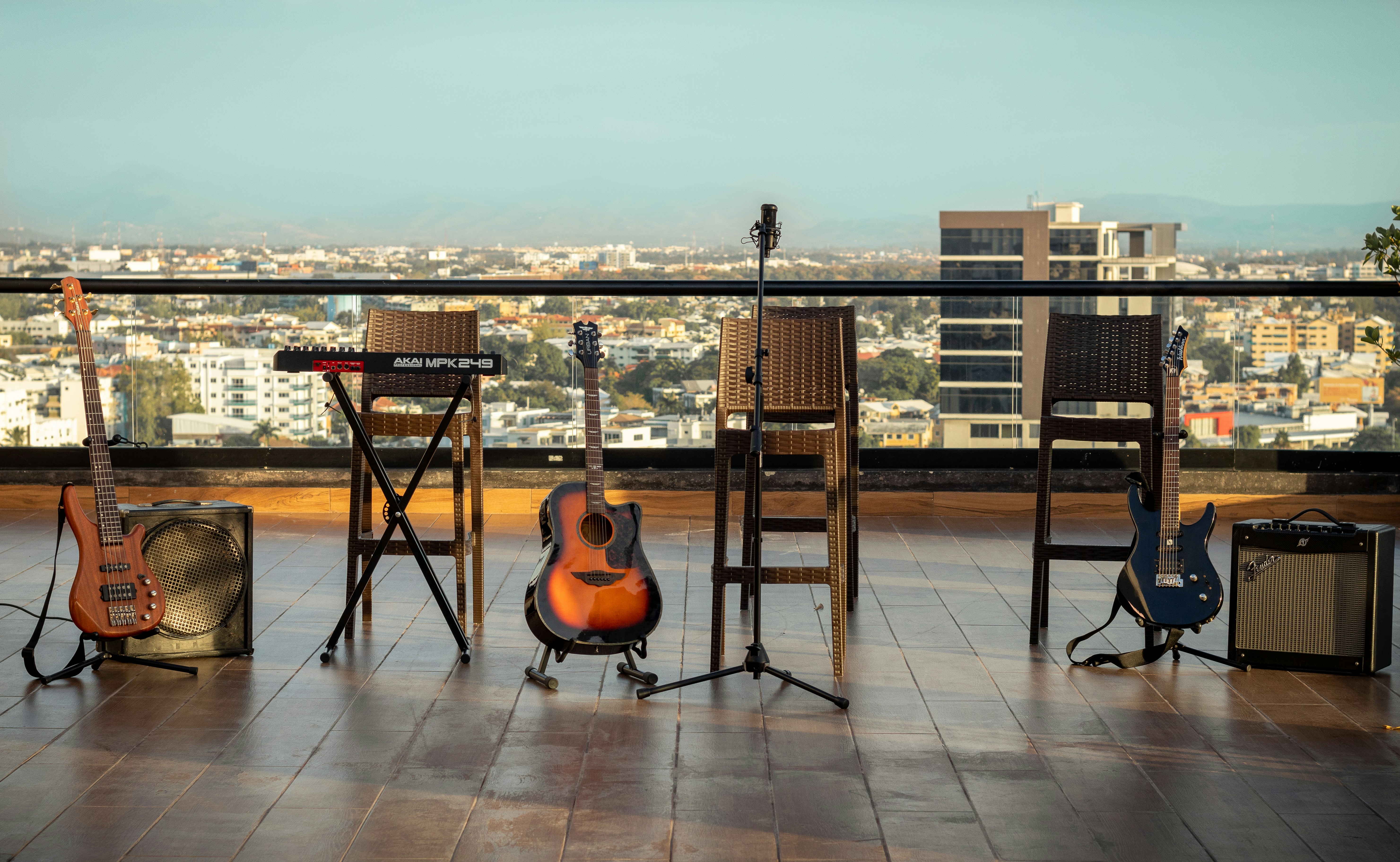 brown acoustic guitar on black steel stand