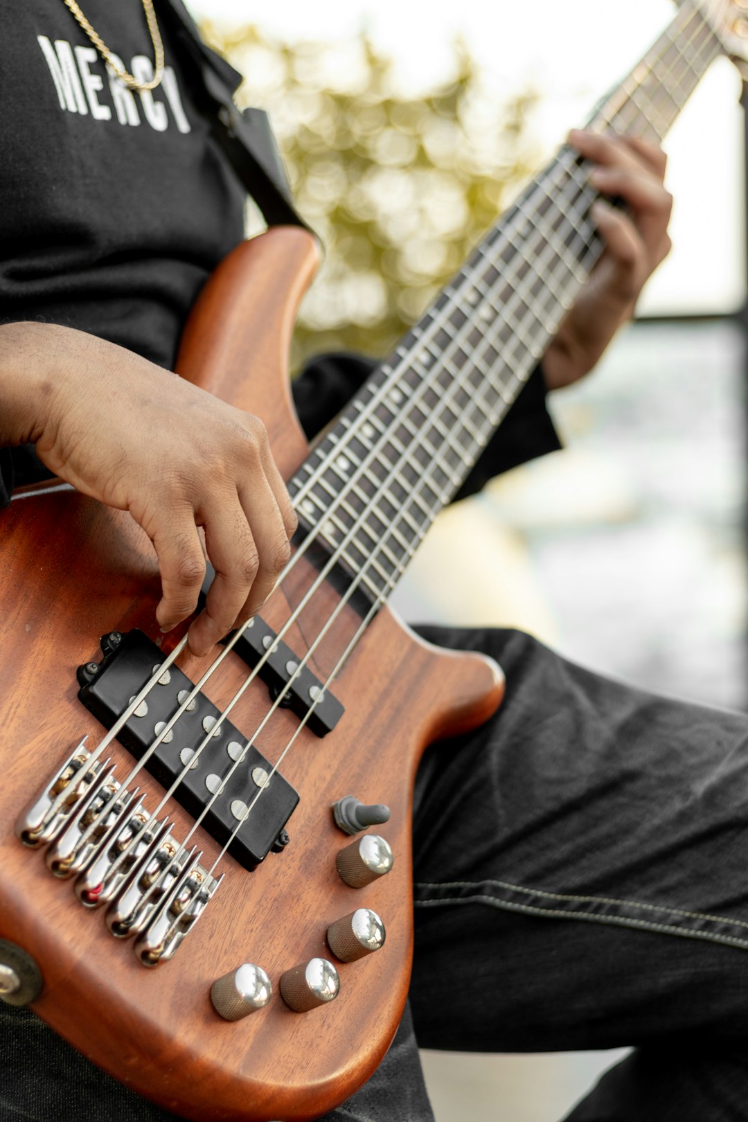 person playing brown and black electric guitar