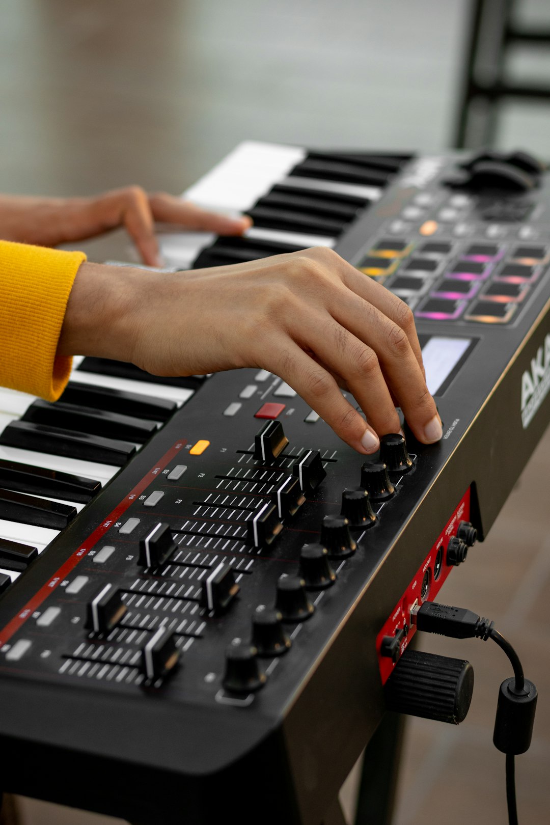 person playing black and white electric keyboard