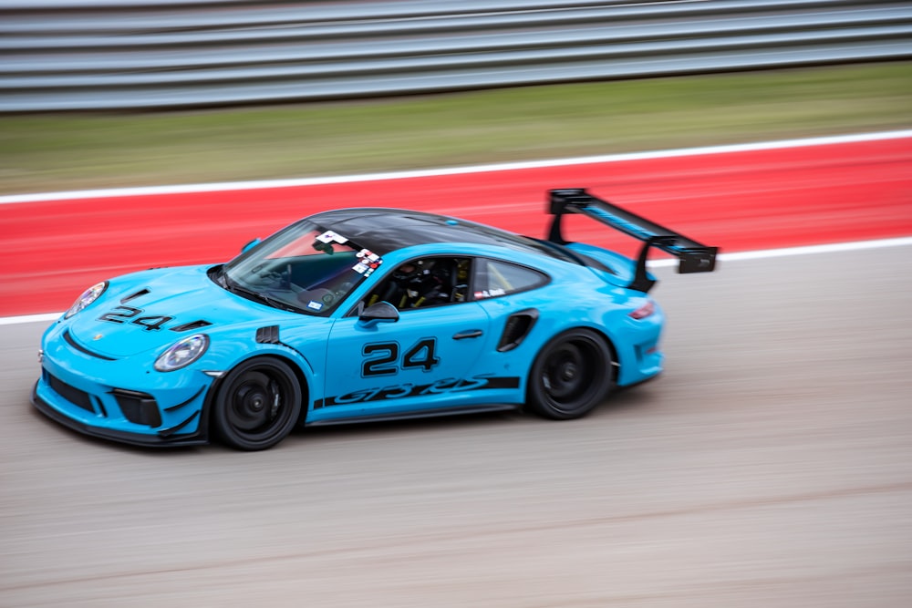 blue and black porsche 911 on track